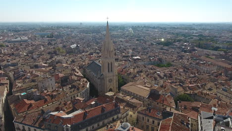 Zoom-out-over-Montpellier-Sainte-Anne-church-sunny-day-aerial-view